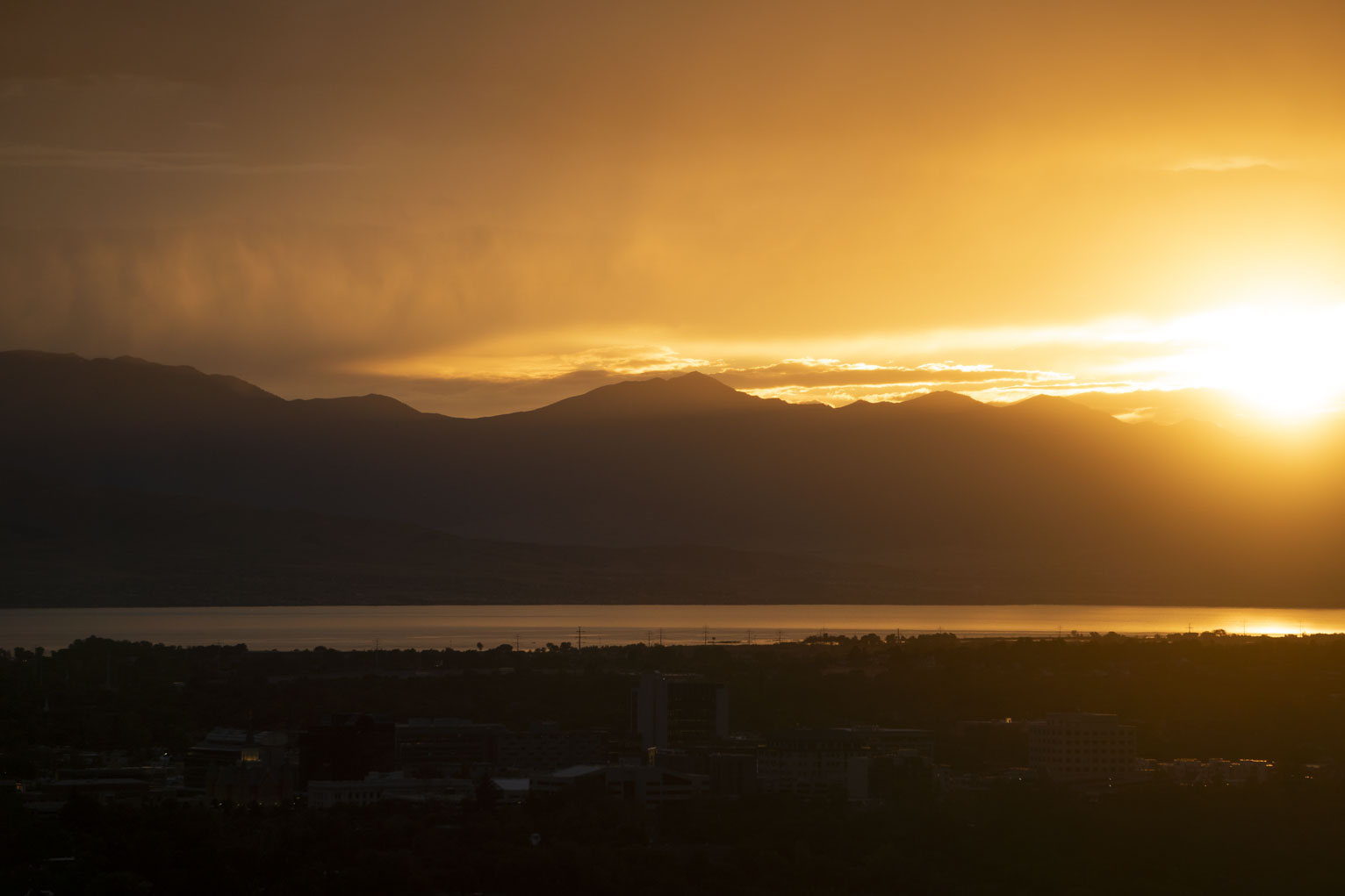 The sun sets behind the mountains